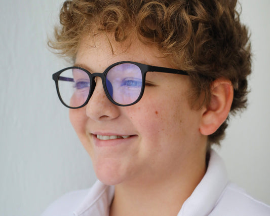 Young person wearing black Bariq DreamGlow glasses